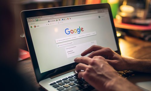 someone is typing on a laptop with google search on the screen. generative ai.